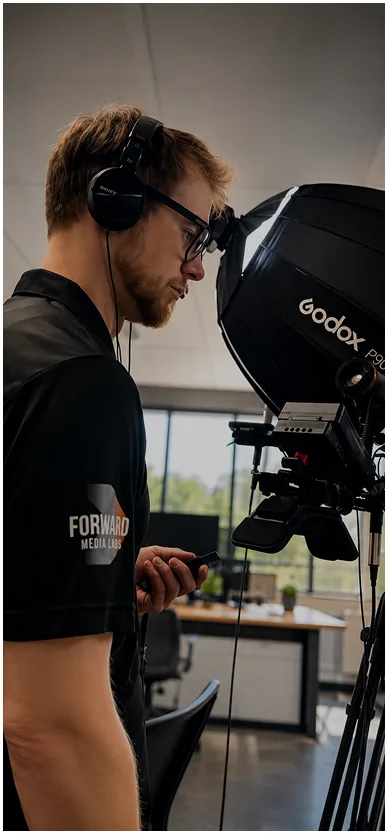A man sets up a camera for video marketing services Calgary in a professional studio